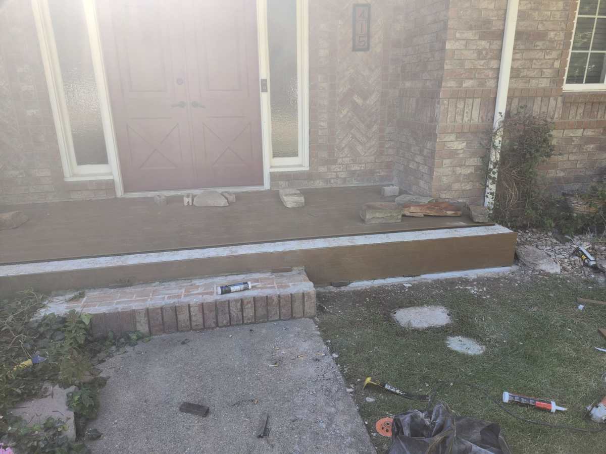 After: new Trex composite decking installed on a Longmont, CO front porch remodel with matching fascia